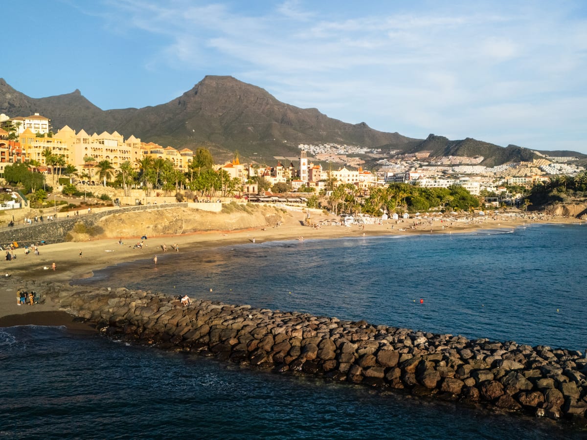 The beach and hotel front at Costa Adeje with Roque del Conde behind