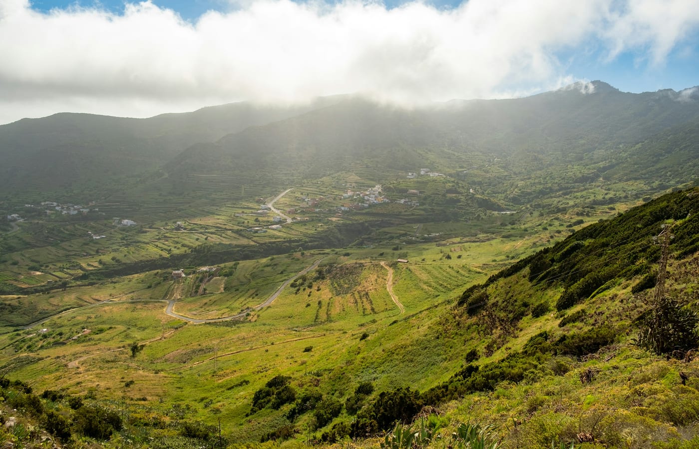 Green terraced hillsides on the northern slope of Tenerife with cloud sitting against the ridge